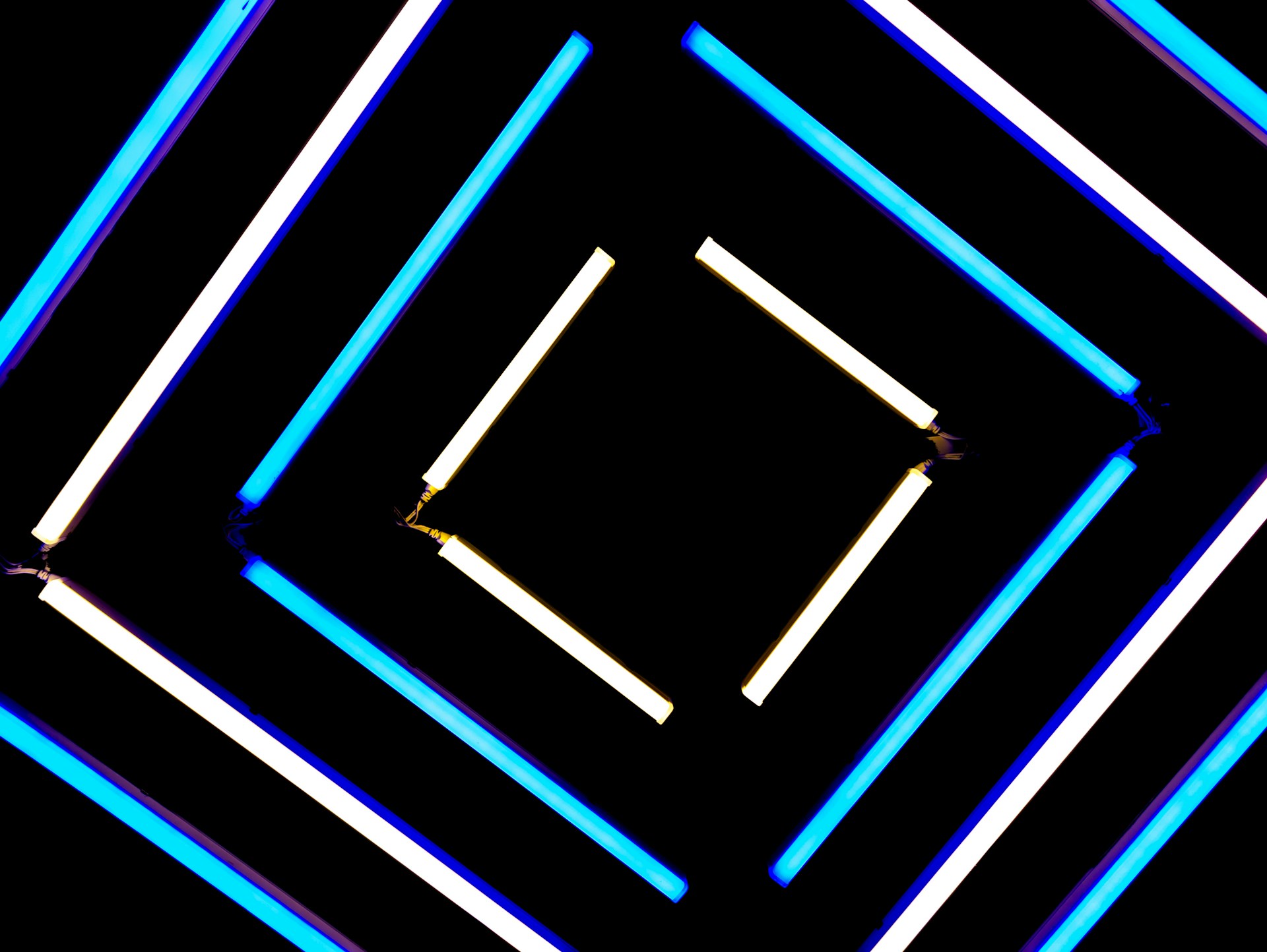 a black background with blue and white lights