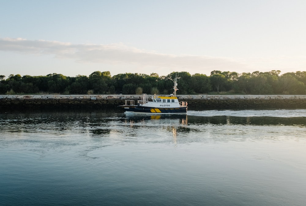 a boat is traveling on the water near a dock