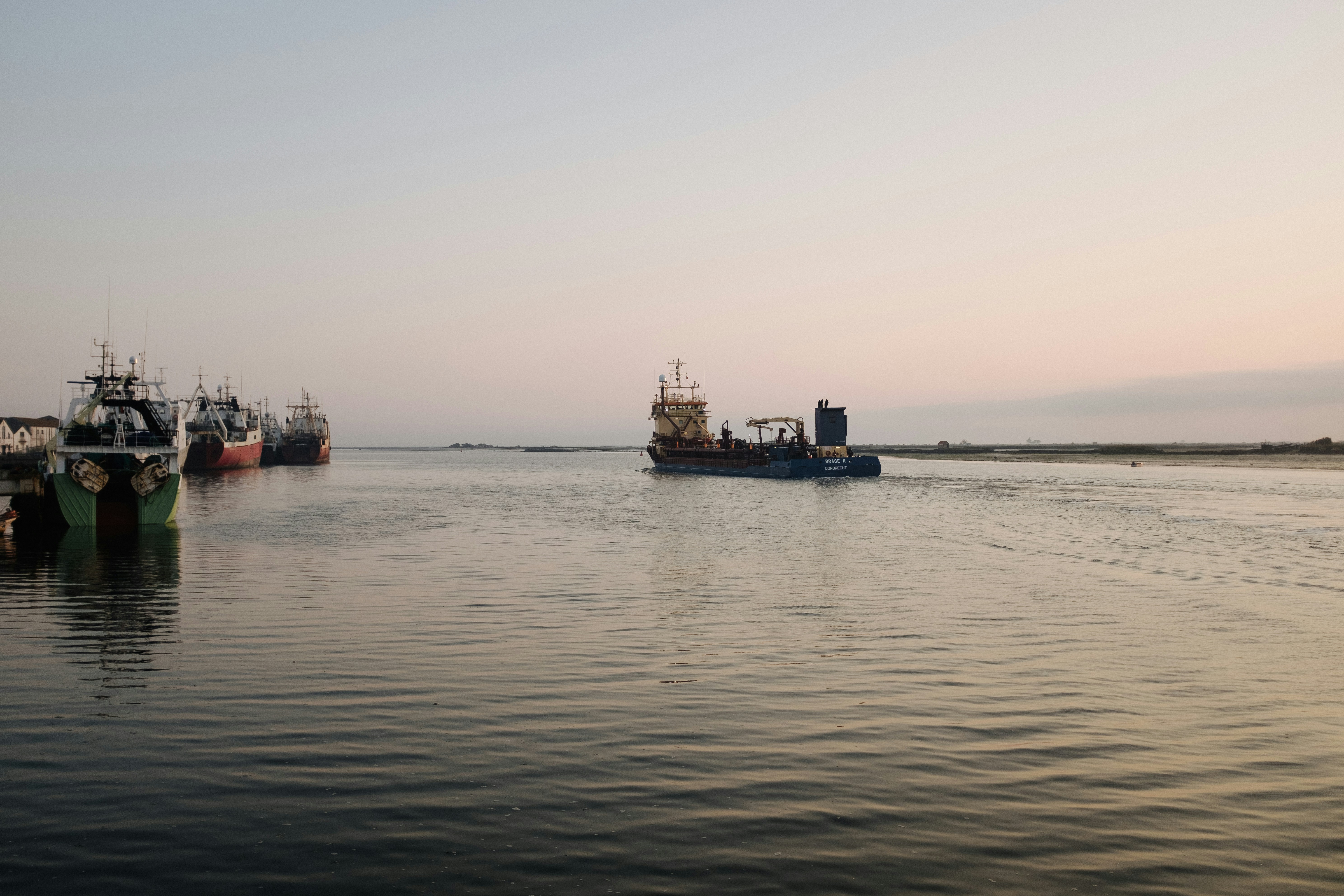 a group of boats floating on top of a body of water, 