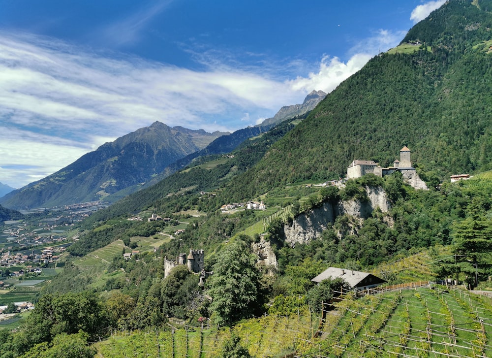 a scenic view of a valley with mountains in the background