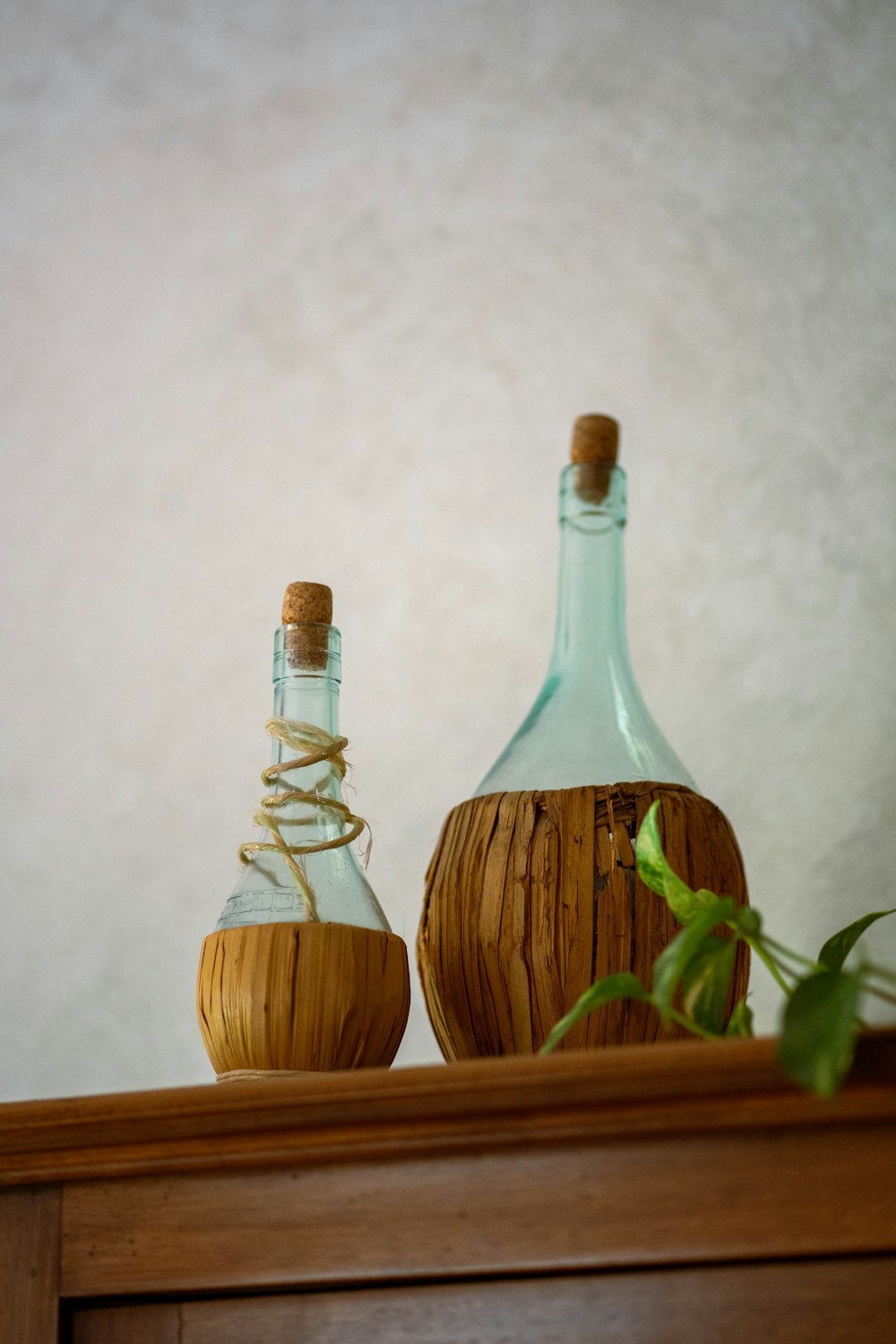 a couple of bottles sitting on top of a wooden shelf