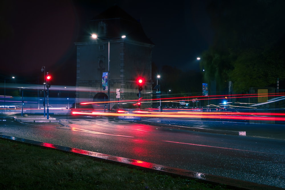 a city street at night with red traffic lights