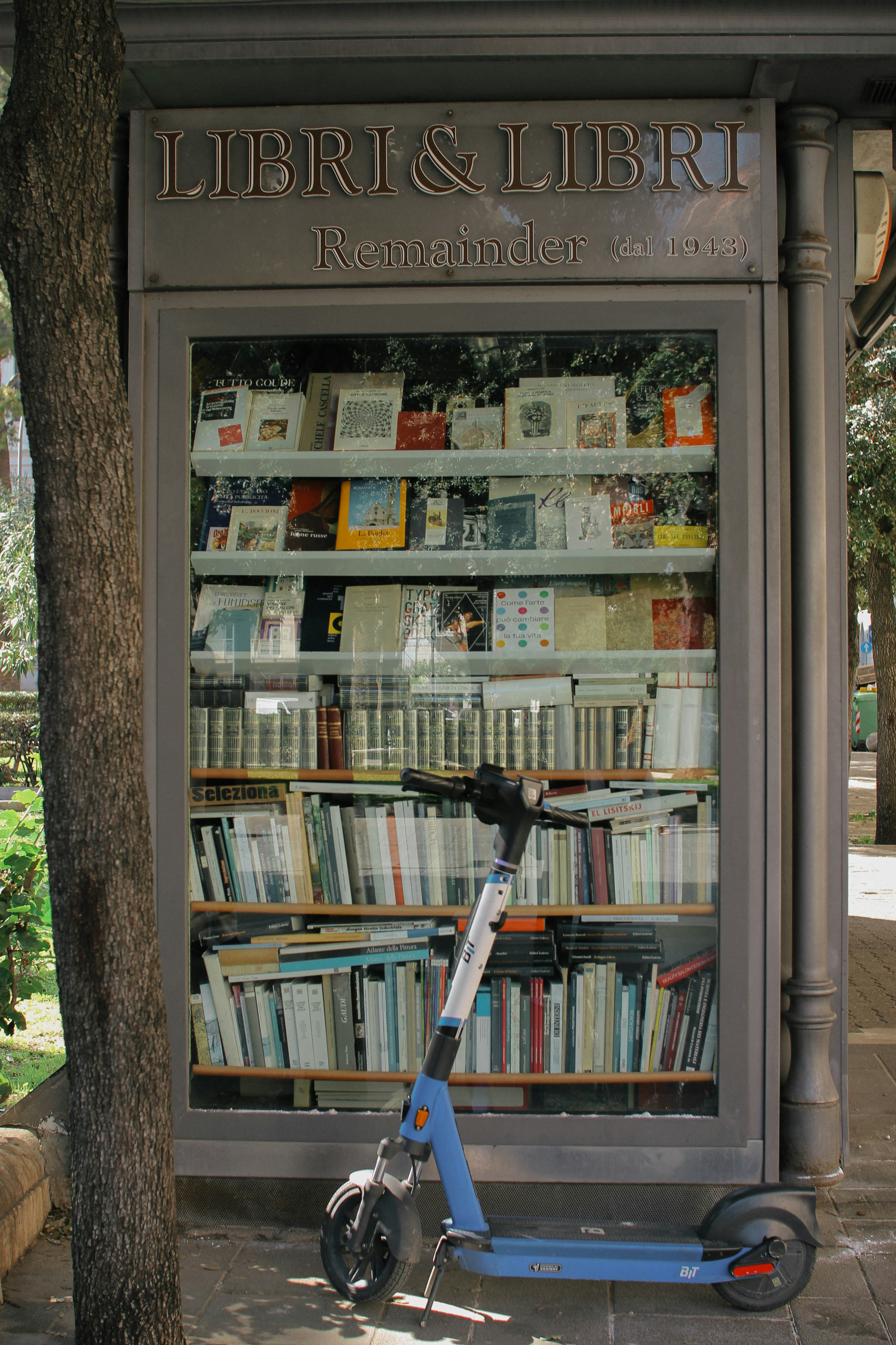 a scooter parked in front of a book store