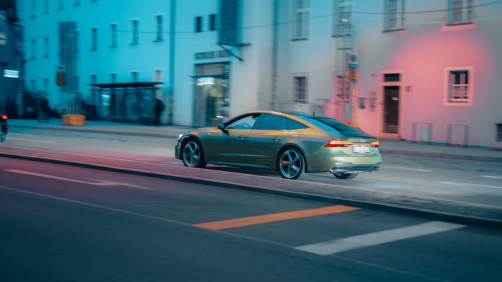 a car driving down a city street at night