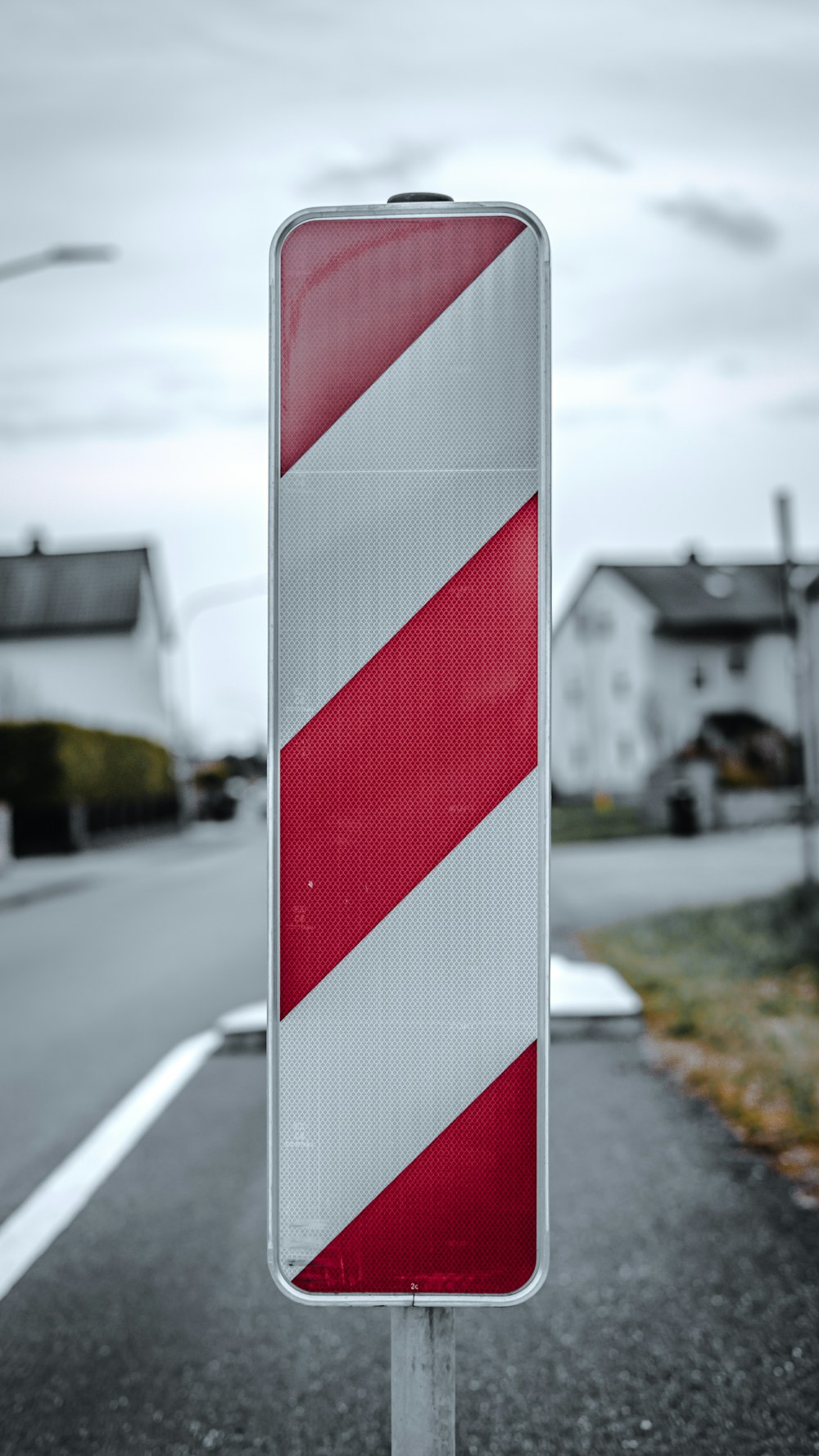 a red and white sign sitting on the side of a road