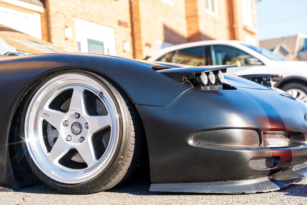 a close up of a car parked on the side of a road