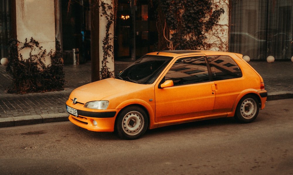 an orange car parked on the side of the road