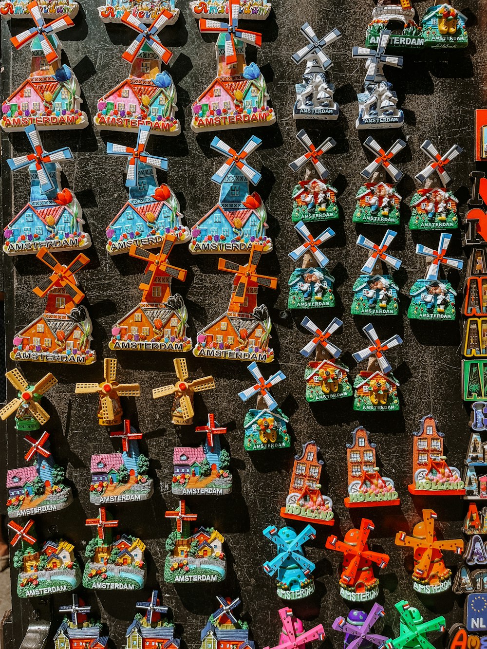 a display of colorfully decorated windmills on a wall
