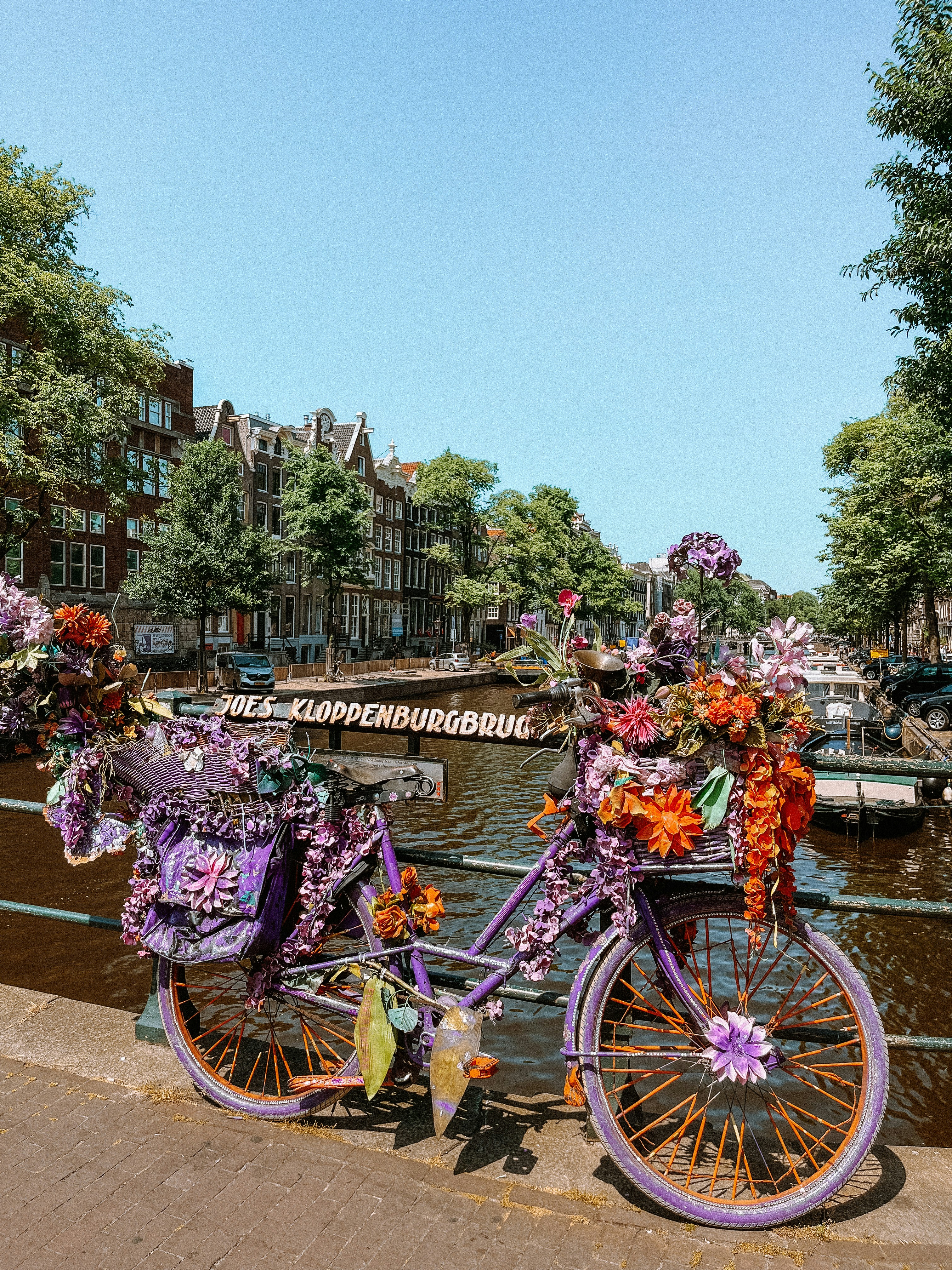 a bicycle decorated with flowers on a bridge