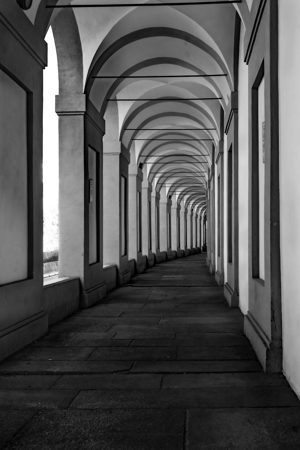 a black and white photo of a row of arches