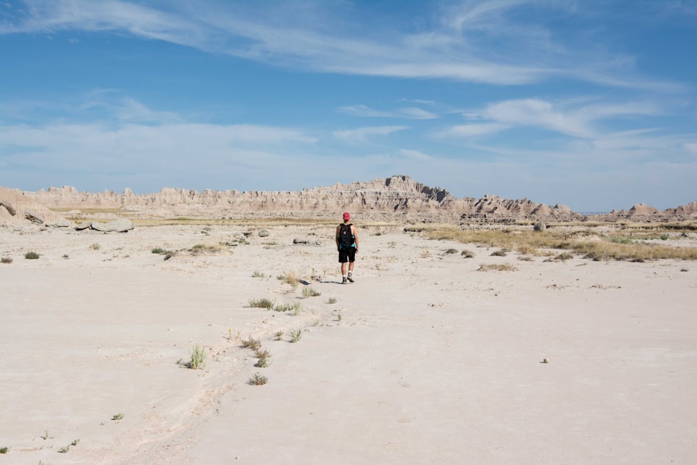 a person standing in the middle of a desert