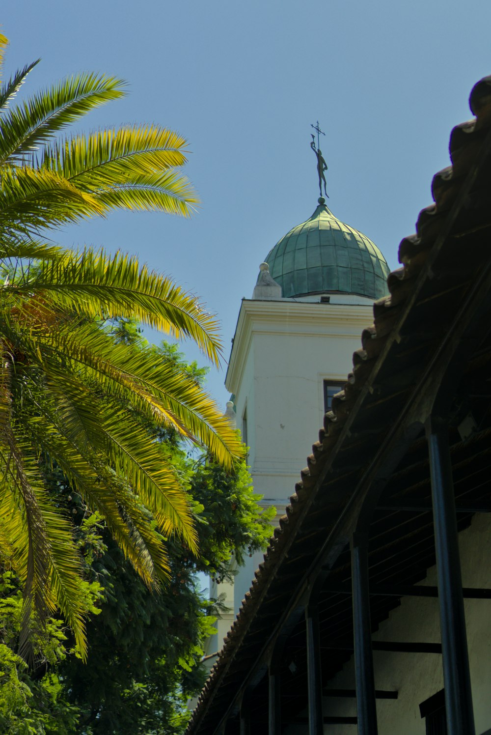 a tall white building with a green dome