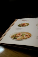 a menu is open on a wooden table