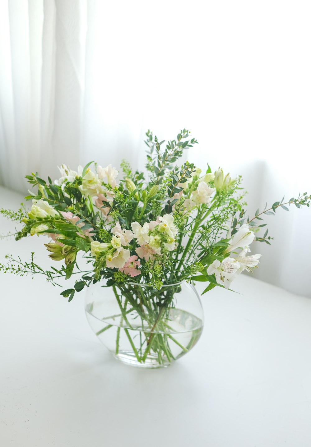 a vase filled with white flowers on top of a table