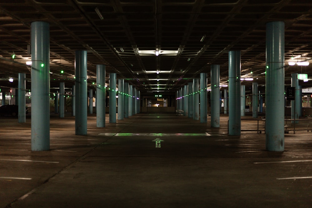 an empty parking garage with columns and lights