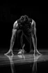 a man kneeling down on a basketball court