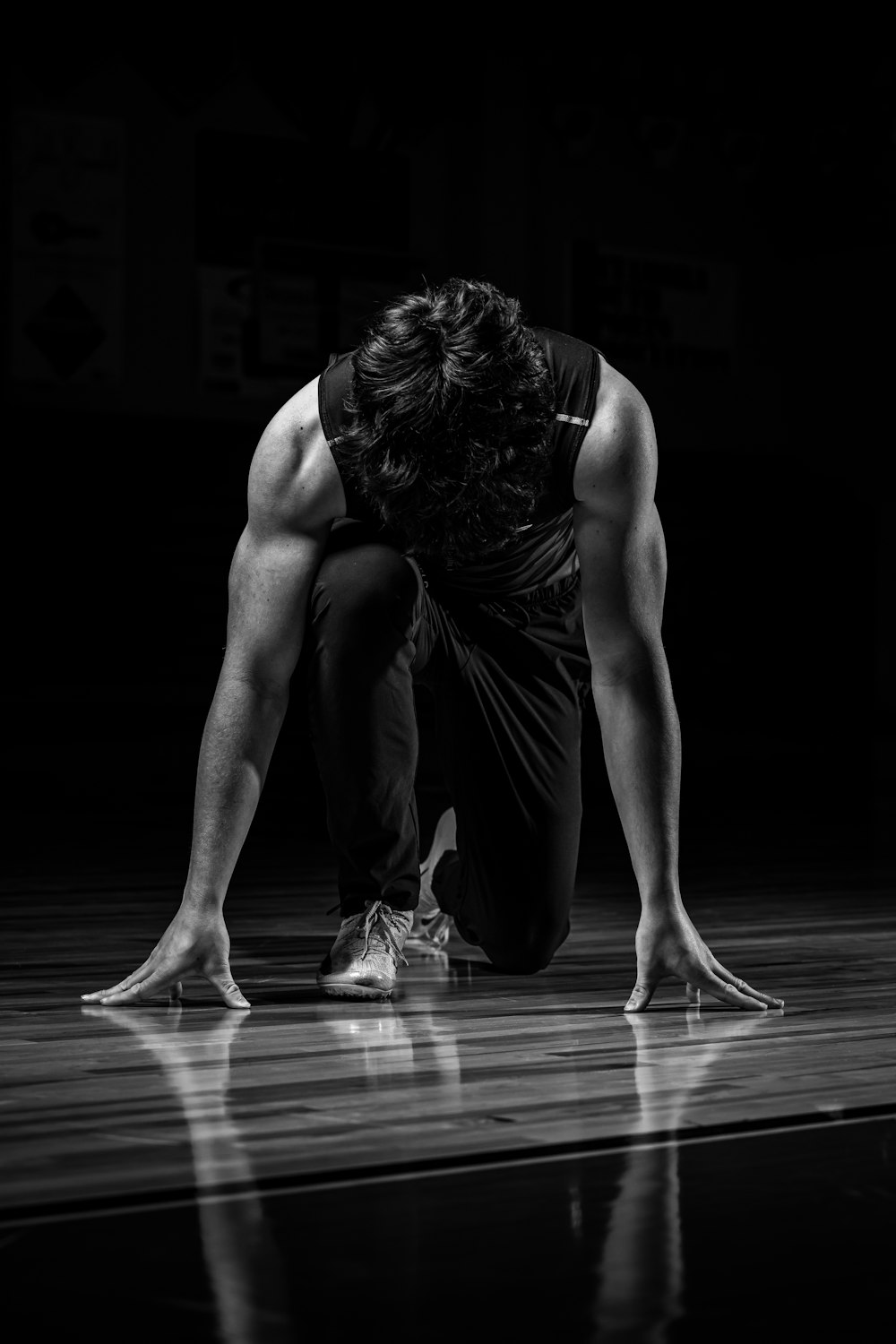 a man kneeling down on a basketball court