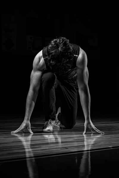 a man kneeling down on a basketball court