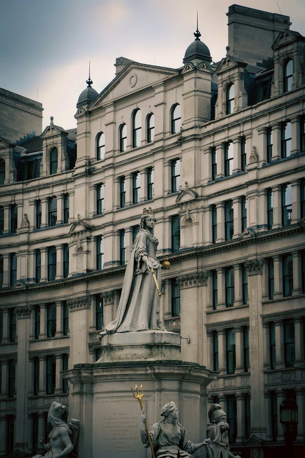 a statue in front of a large building