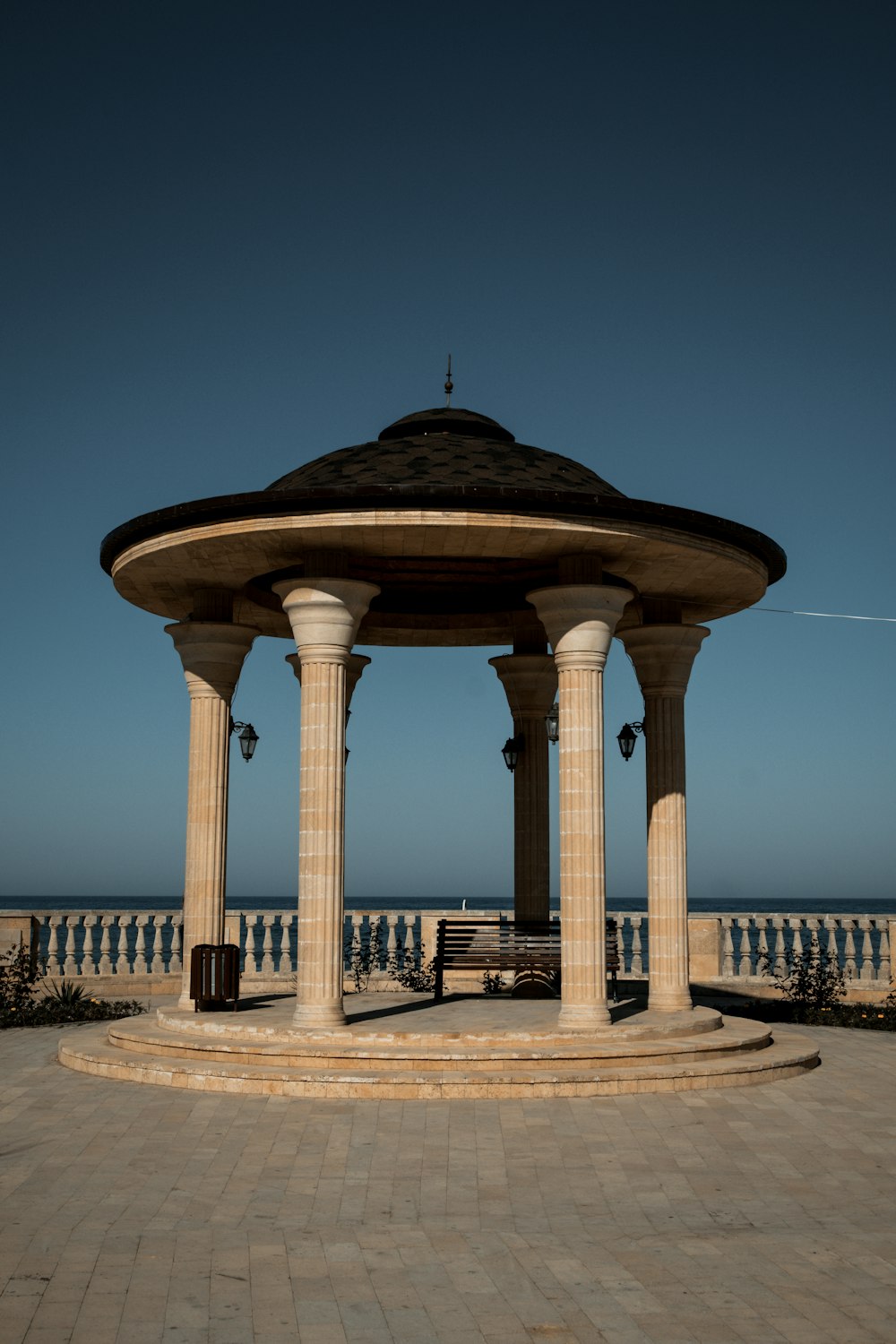 a gazebo sitting on top of a stone walkway