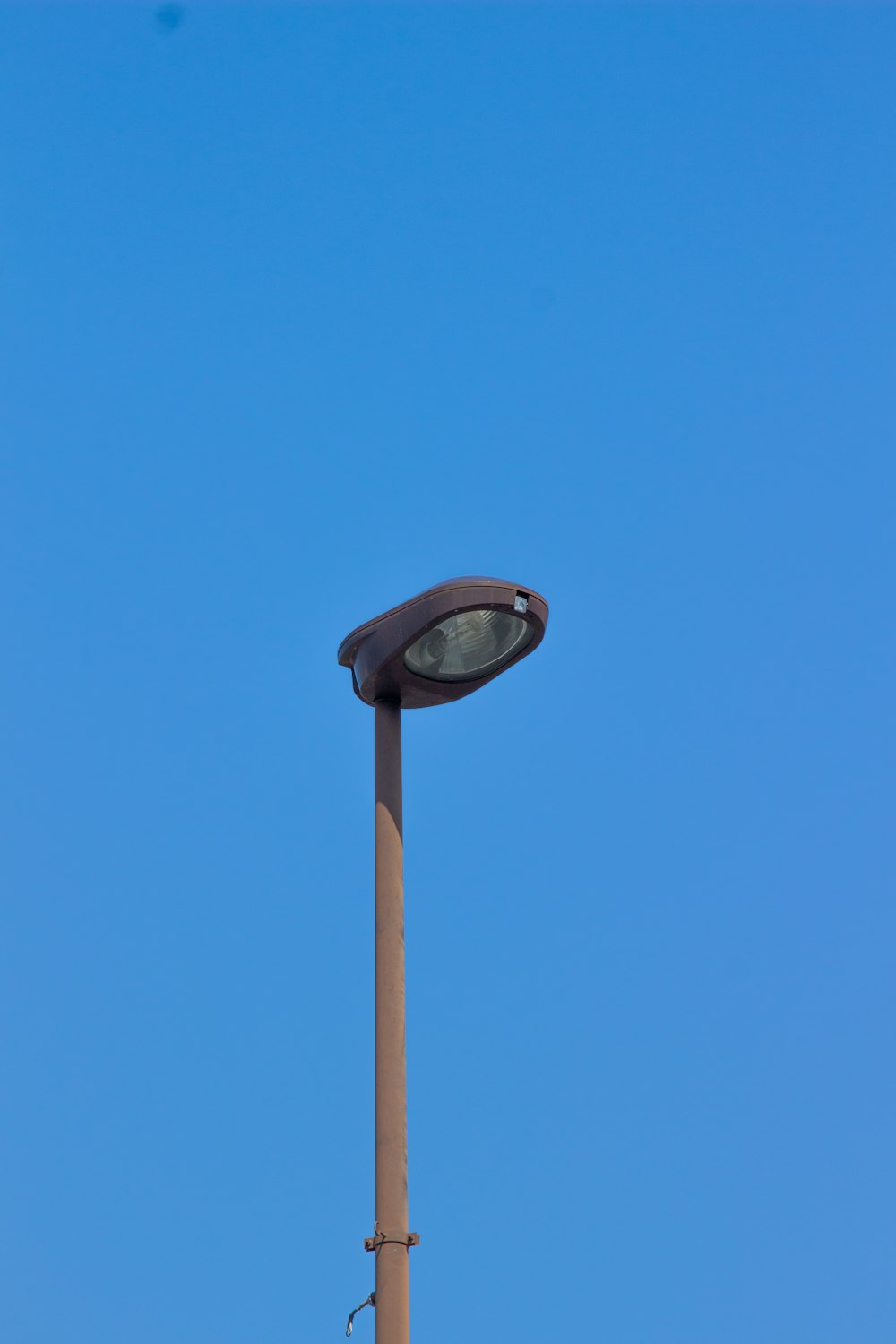 a street light with a blue sky in the background