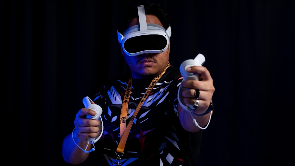 a man wearing a blindfold holding a game controller
