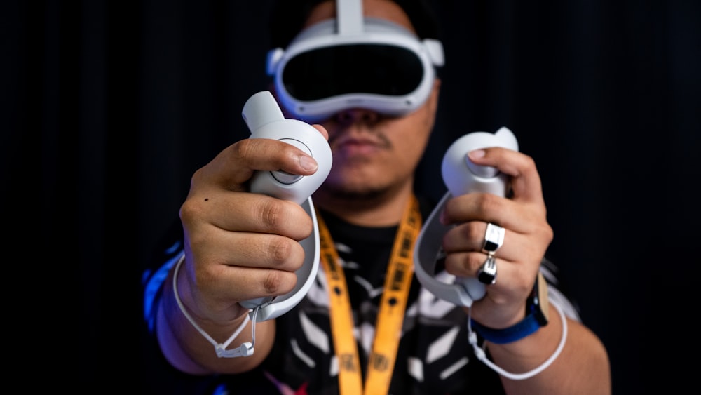 a man holding a video game controller in his hands