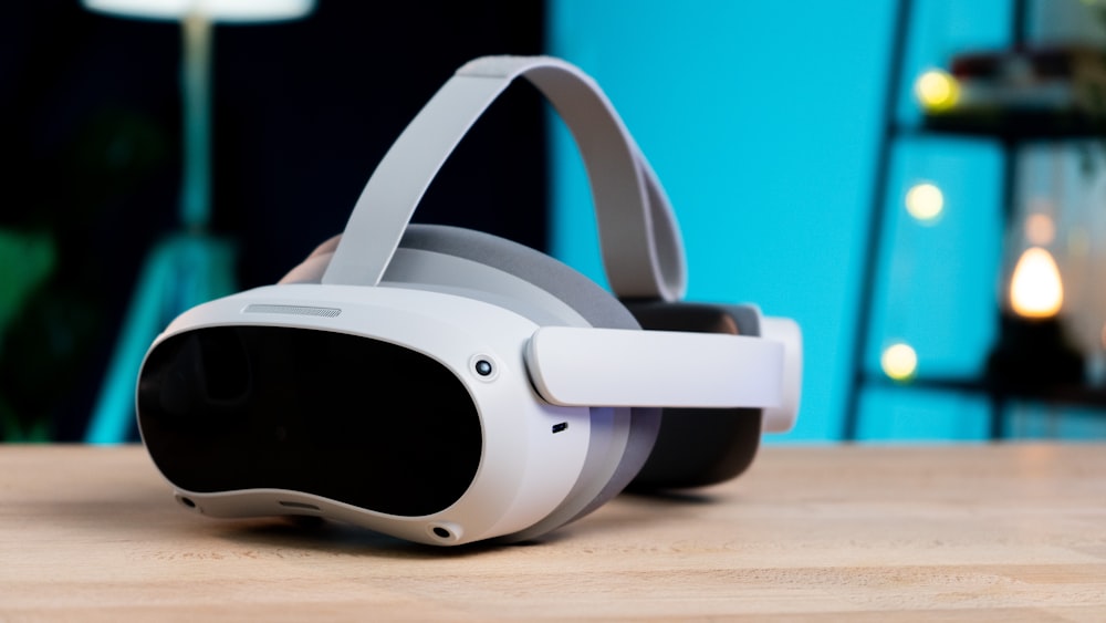 a pair of white headphones sitting on top of a wooden table