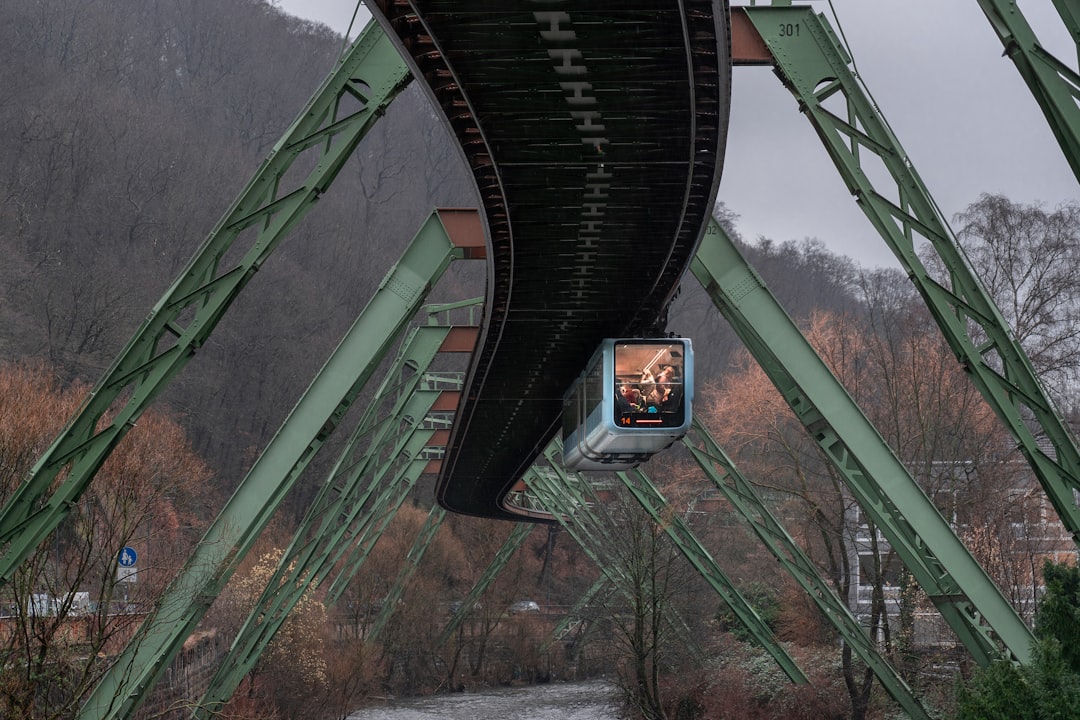 a train going over a bridge on a cloudy day, Tram