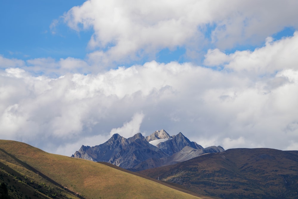 a view of a mountain range with clouds in the sky