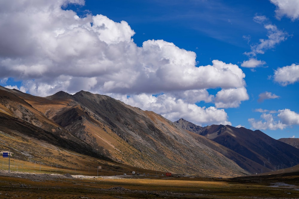 a scenic view of a mountain range with clouds in the sky