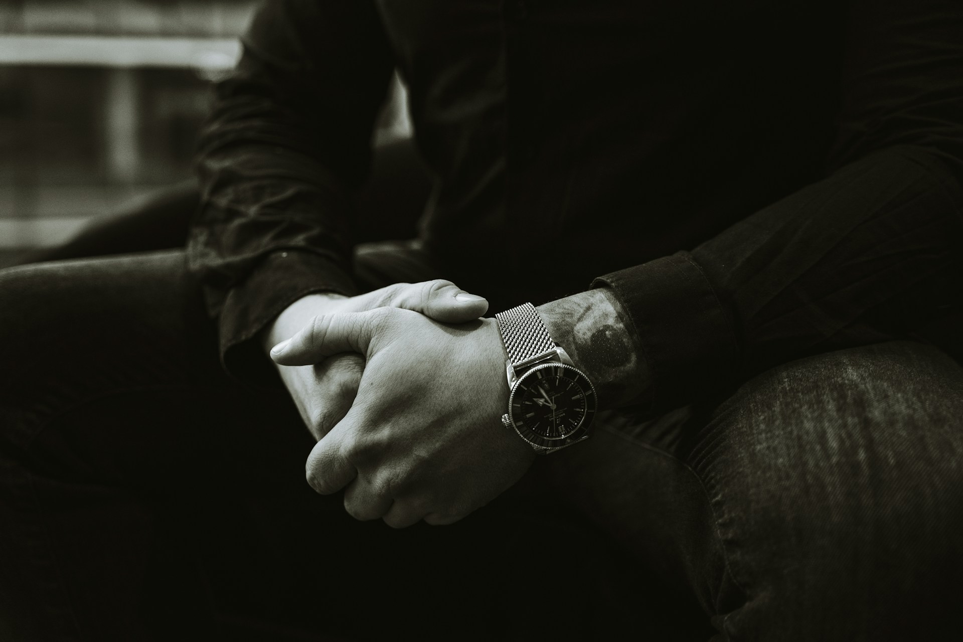 a black and white photo of a person holding hands