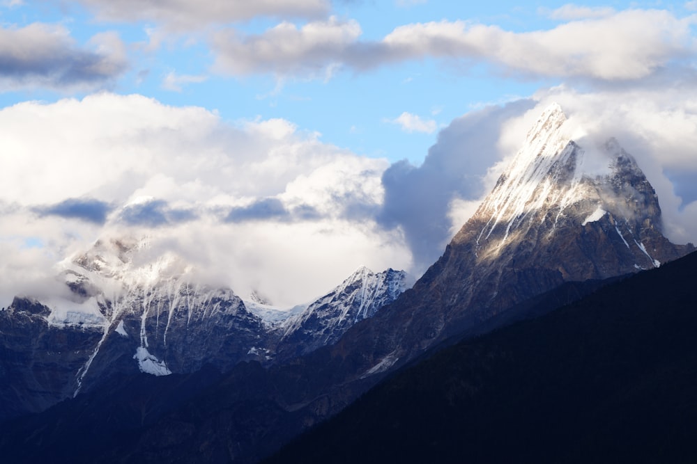 a view of a mountain range with clouds in the sky