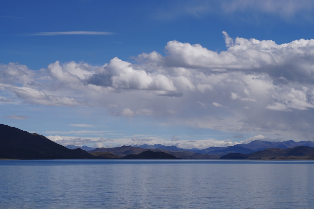 a large body of water with mountains in the background