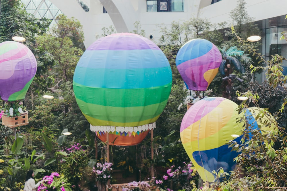a group of colorful hot air balloons in a garden