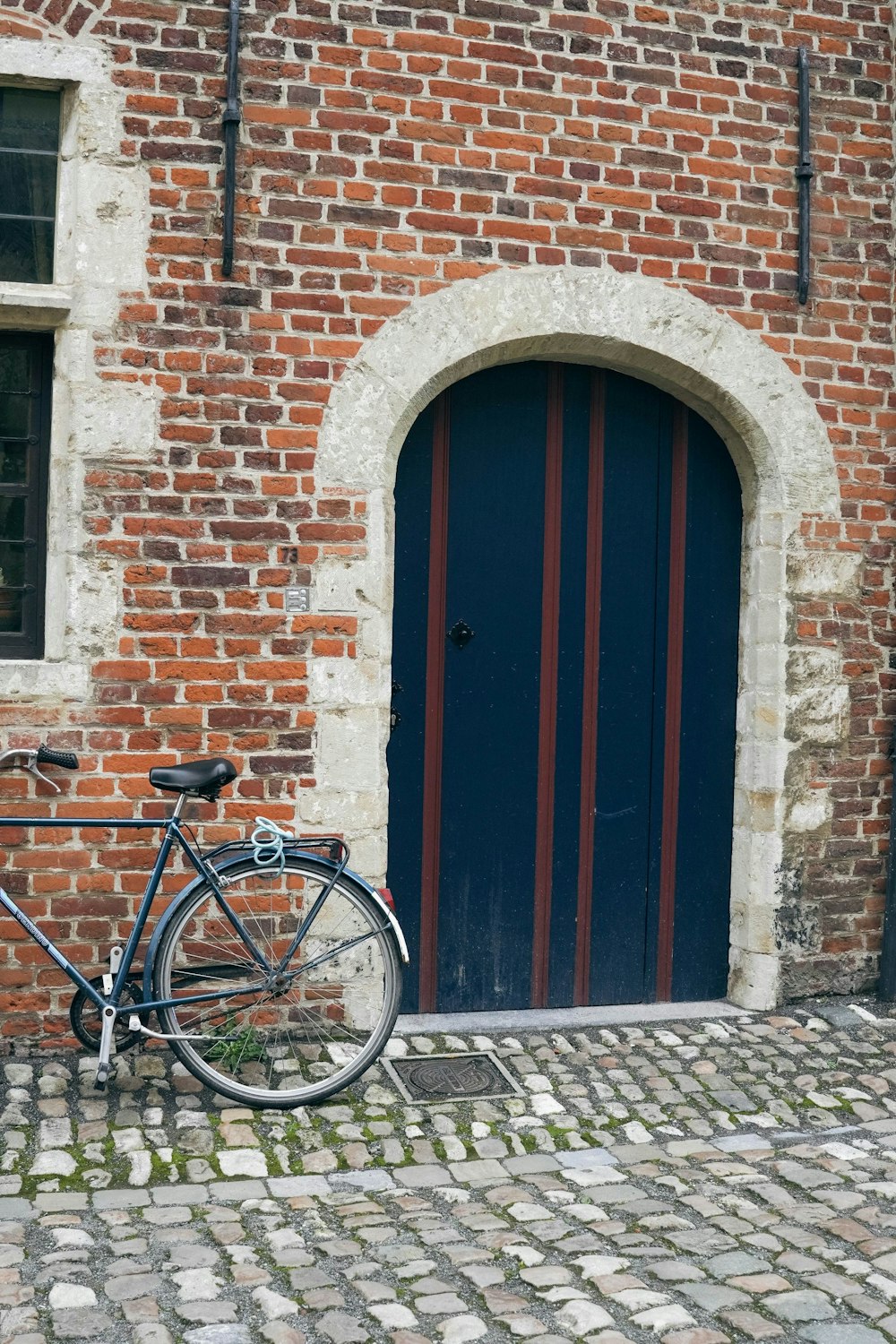 a bicycle parked in front of a brick building