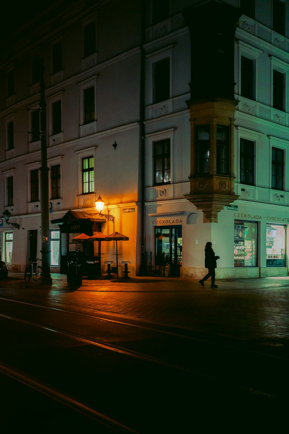 a person walking down a street at night