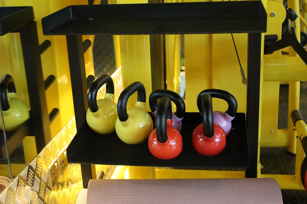 a row of kettles sitting on top of a shelf