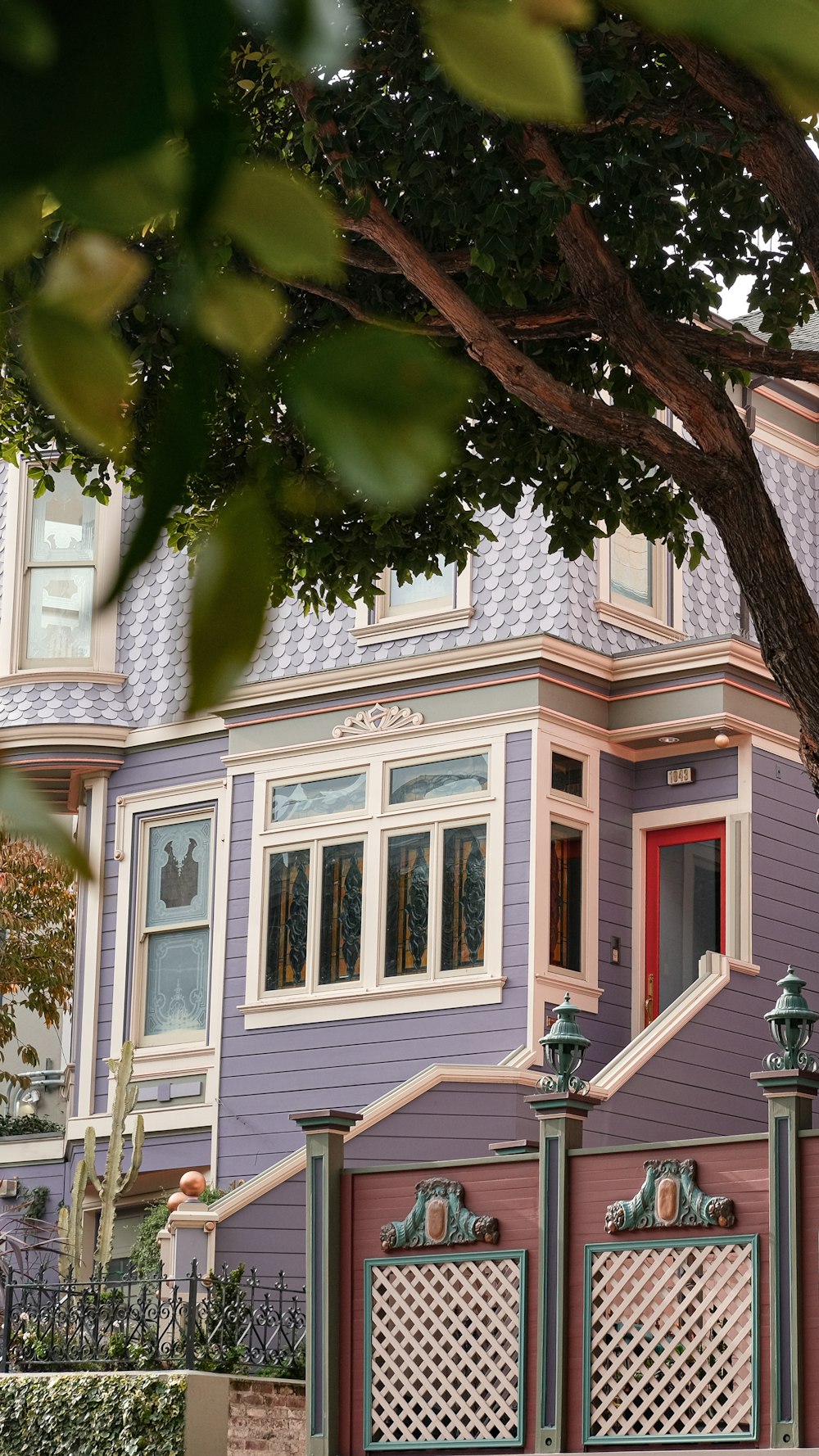 a purple house with a red door and window