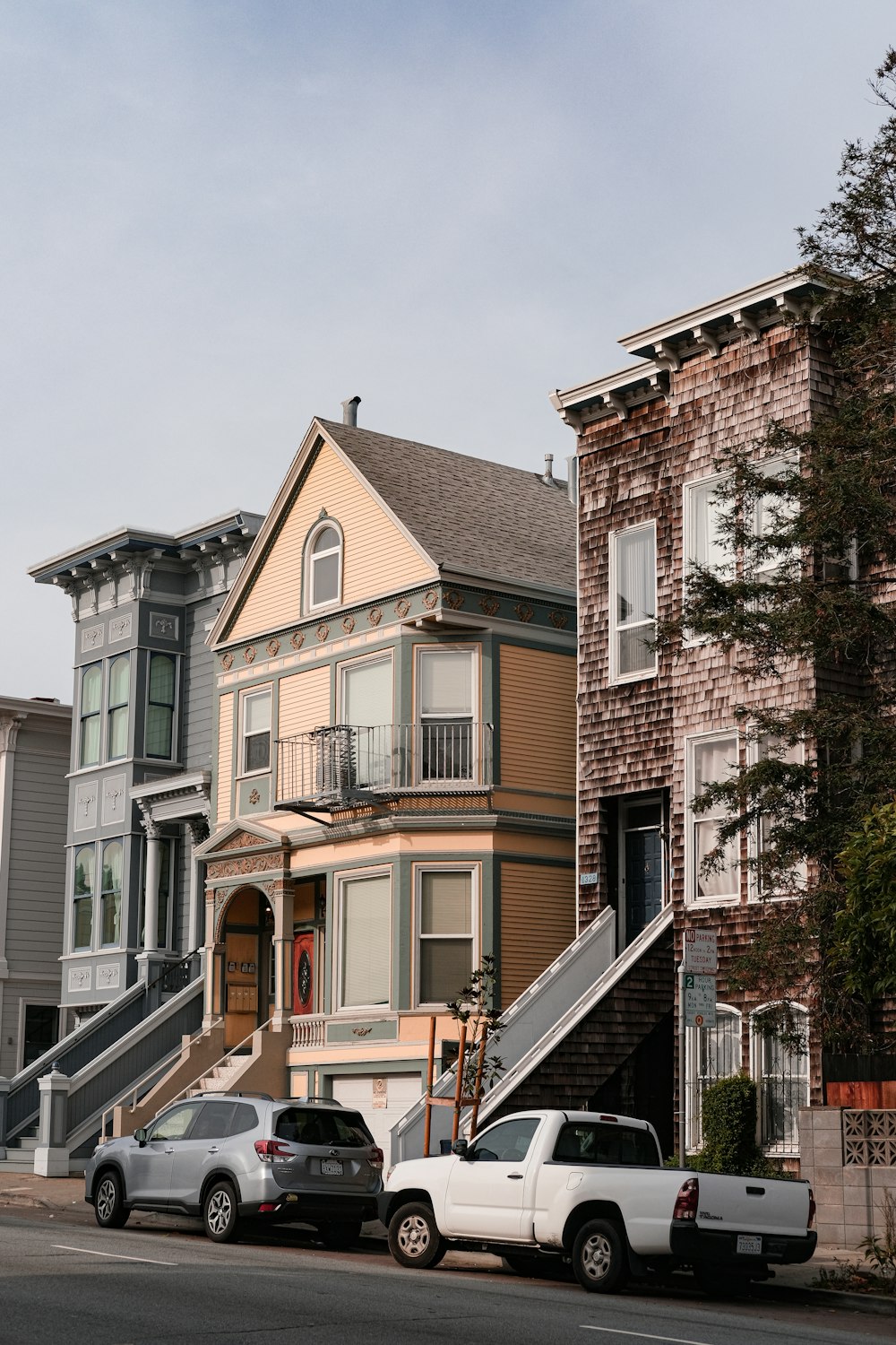 a couple of cars parked in front of a house