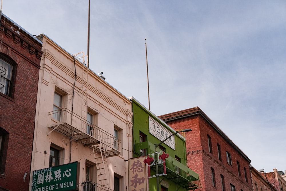 a row of brick buildings with a green fire escape