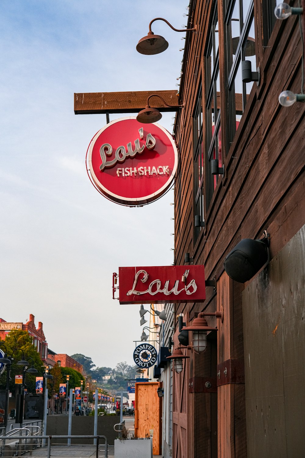 a red sign hanging from the side of a building