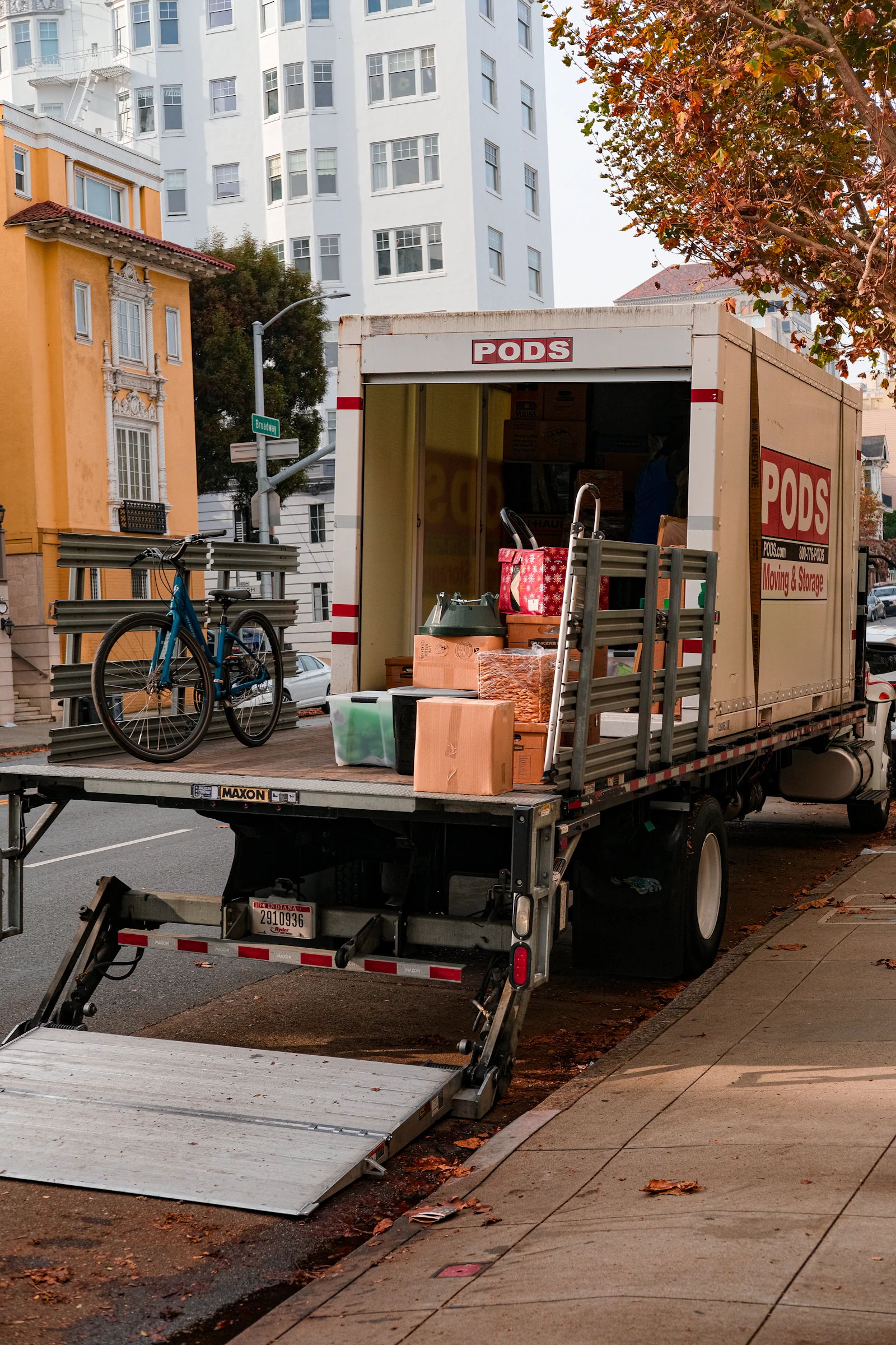 A moving truck loaded with boxes and furniture, parked and ready