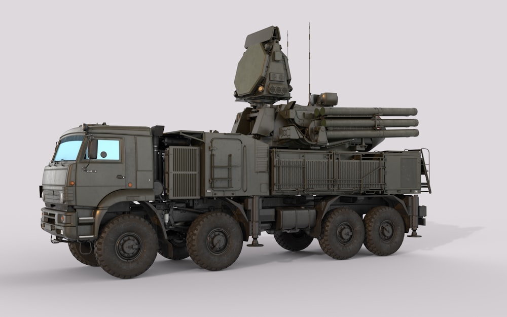 a military truck with a missile on the back of it
