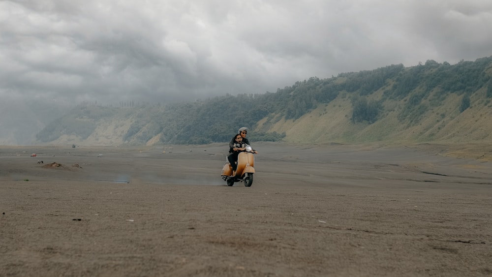 a person riding a motorcycle on a dirt road