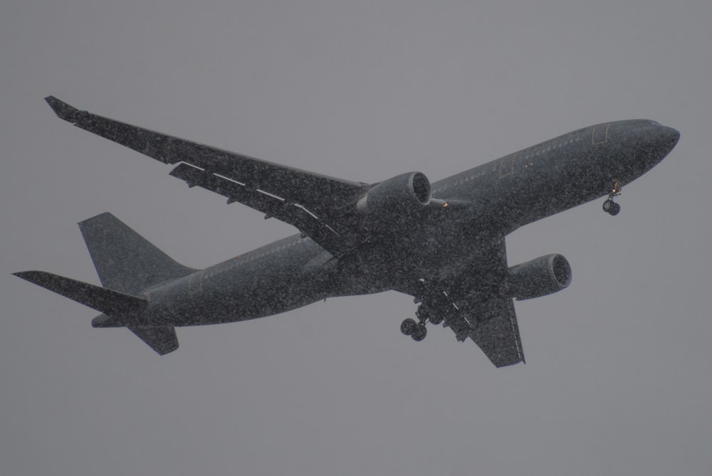 a large jetliner flying through a cloudy sky