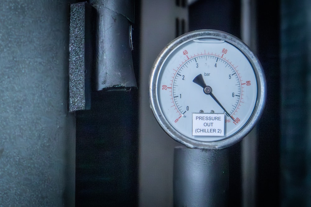 a pressure gauge attached to a pipe in a room