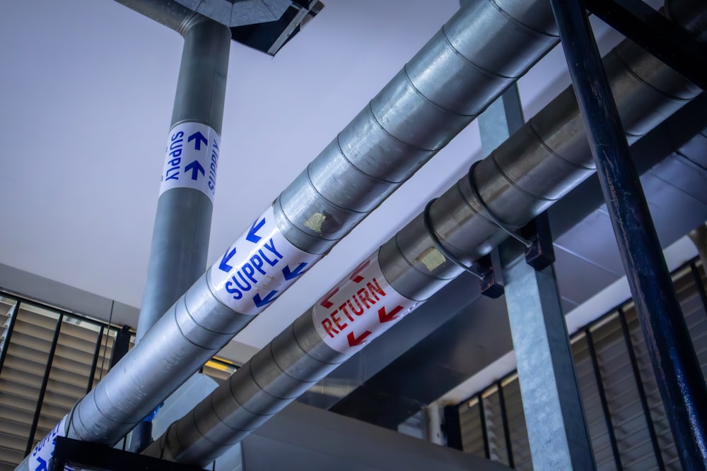 a metal pole with a bunch of signs on it