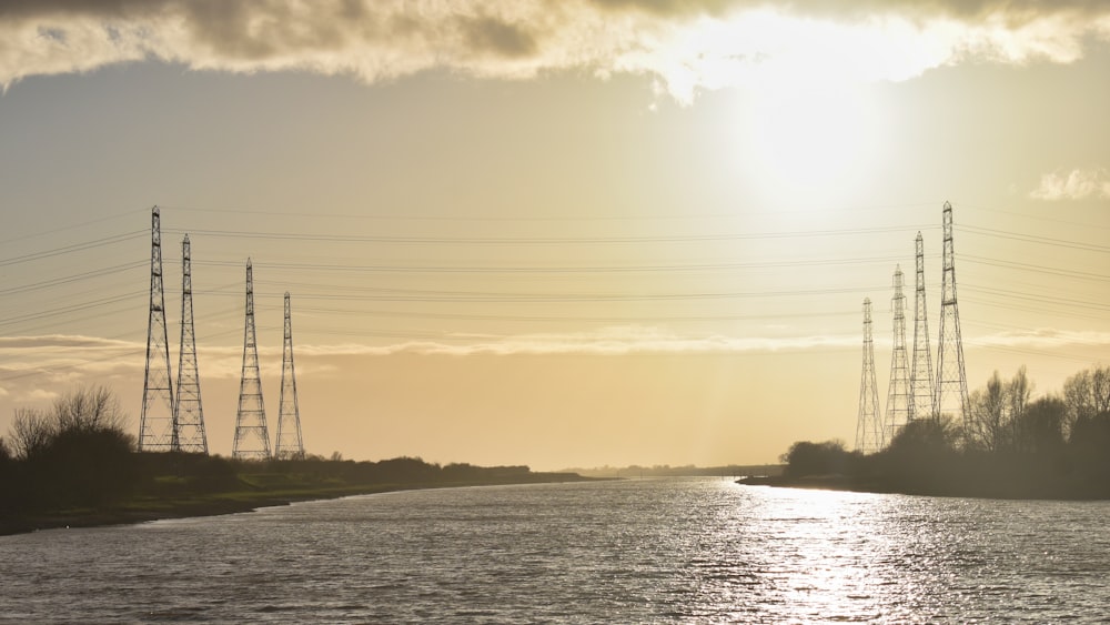 a body of water with power lines in the background