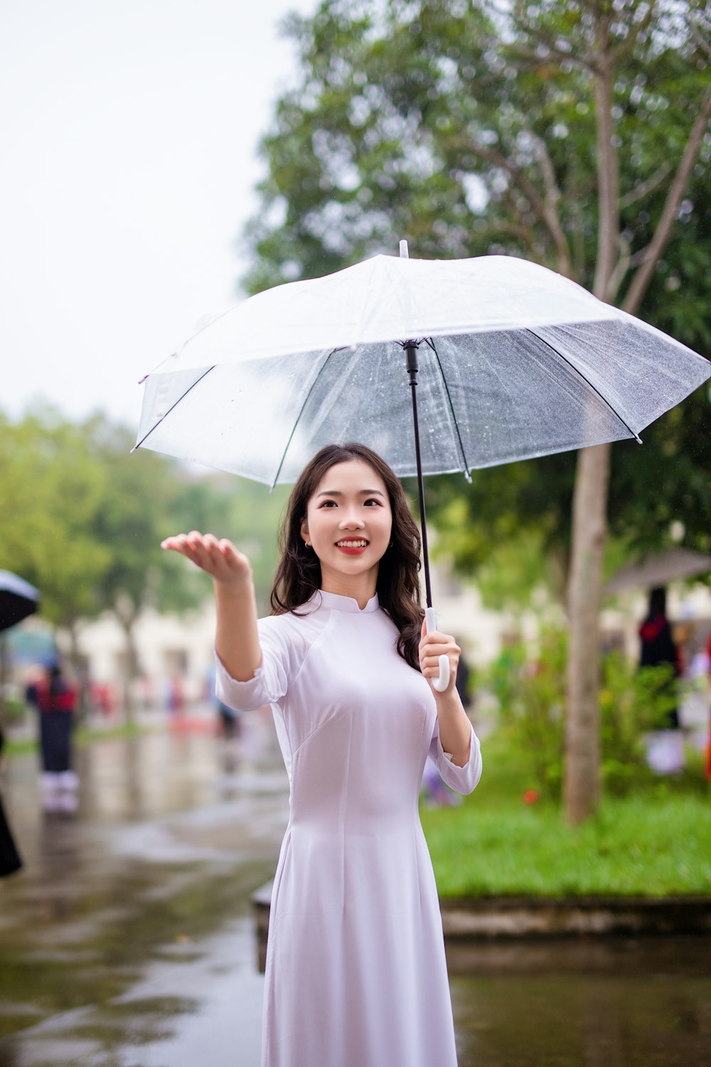 a woman in a white dress holding an umbrella